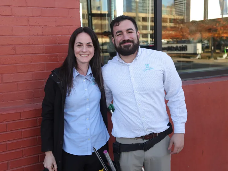 Two Camelot Window Cleaning staff outside a building in downtown Nashville